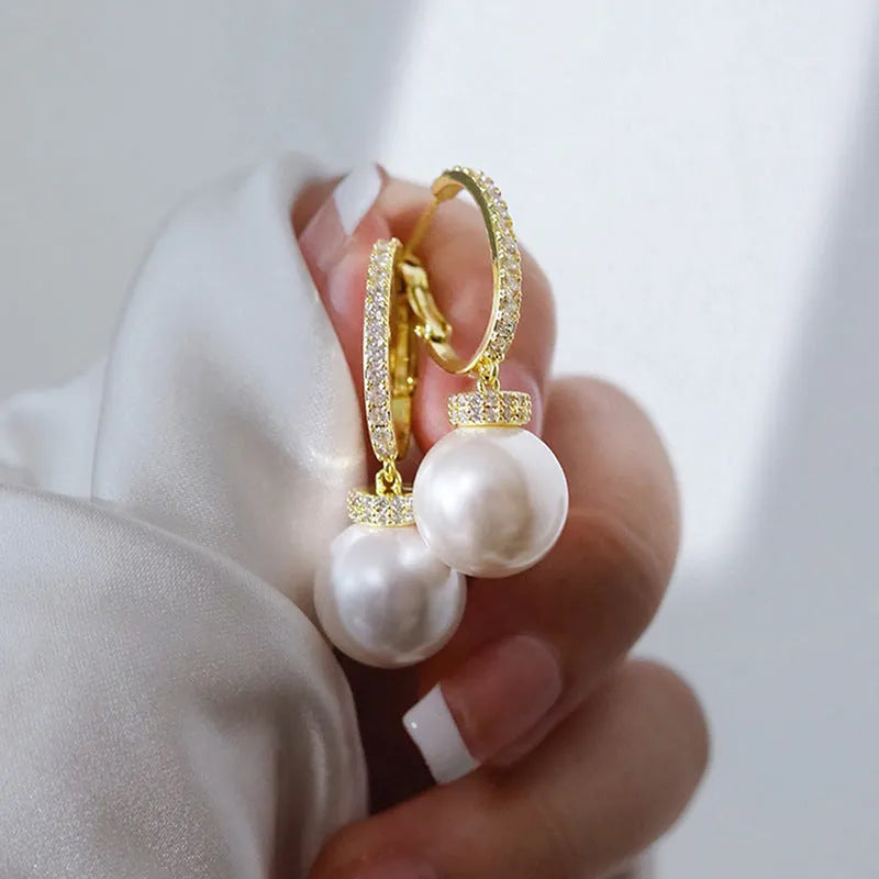 Yellow gold tone geometric earrings with imitation pearl and zircon inlay, round and ring design, one pair.