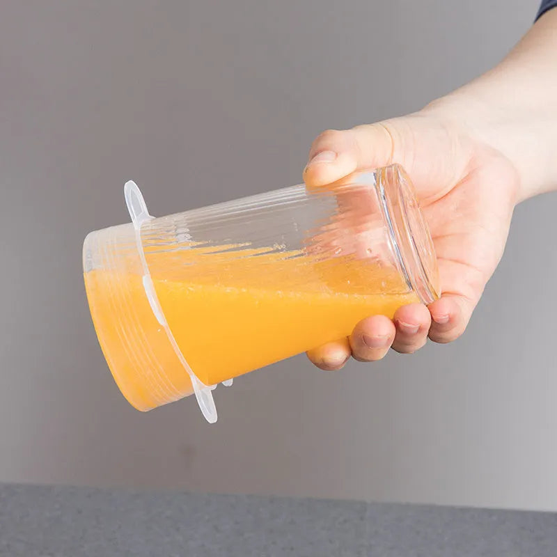 Set of six colourful silicone stretch food covers in different sizes on a kitchen counter.