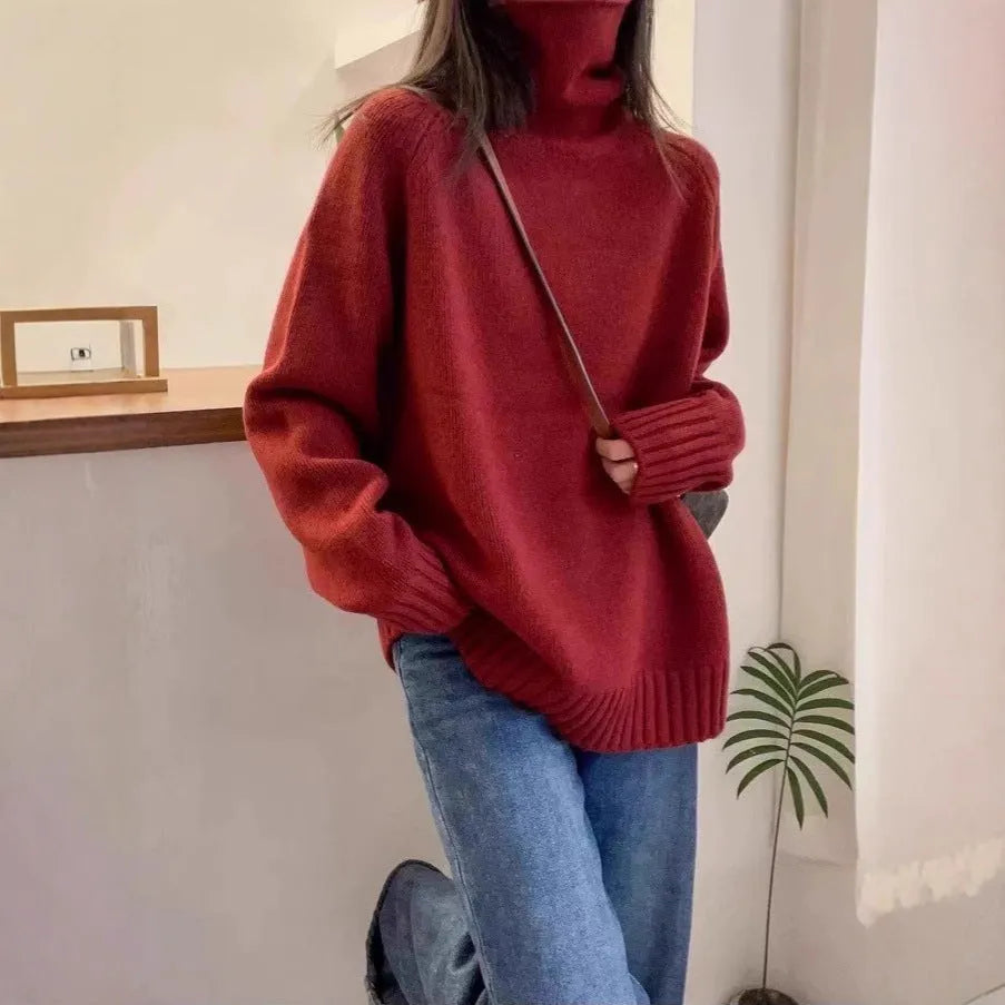 Women's loose grey turtleneck sweater with a textured curling collar and 3D pattern detail.