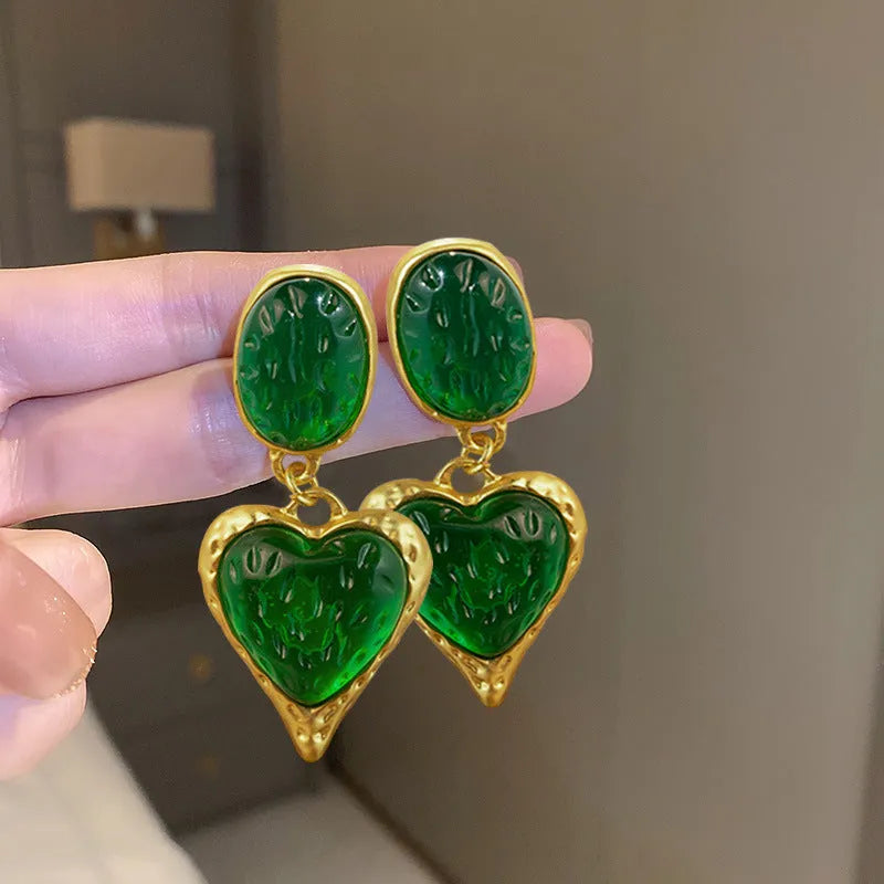 Pleated oval love heart stud earrings in alloy, showing purple, red, green, and yellow with white colour variations.