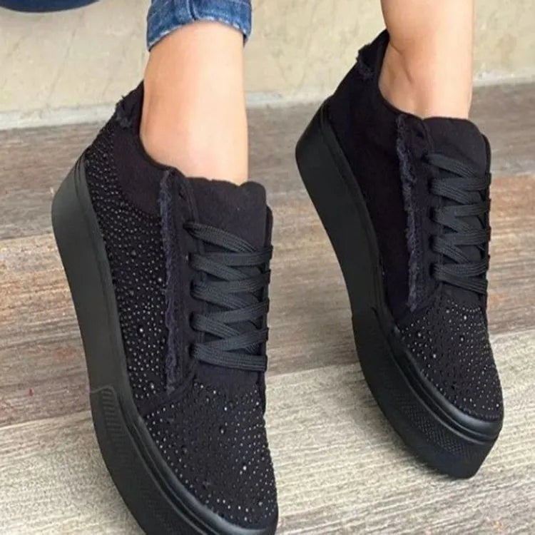 Women's black lace-up casual shoes with rhinestone detail and thick flat rubber sole.