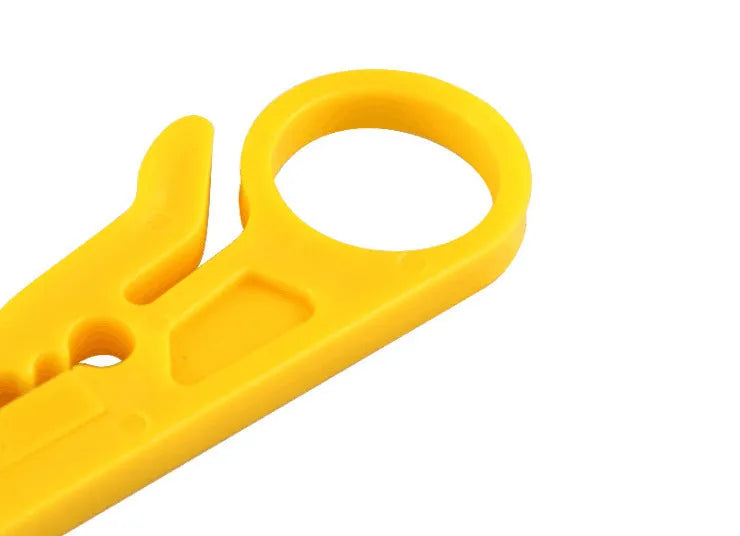 Yellow mini portable wire stripper tool for 0.6mm cables on a workbench.