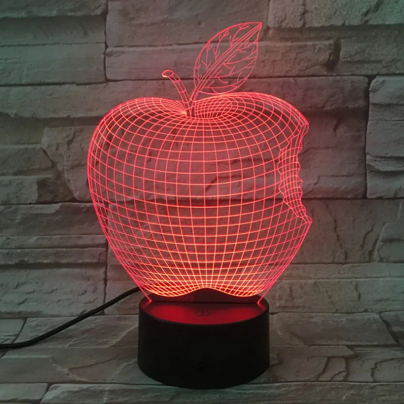 Colourful 3D fruit-shaped acrylic LED night light with touch controls on a dark surface.