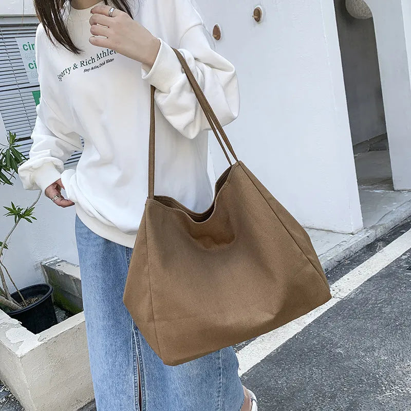 Women's solid colour canvas handbag with double shoulder straps and mobile phone pocket