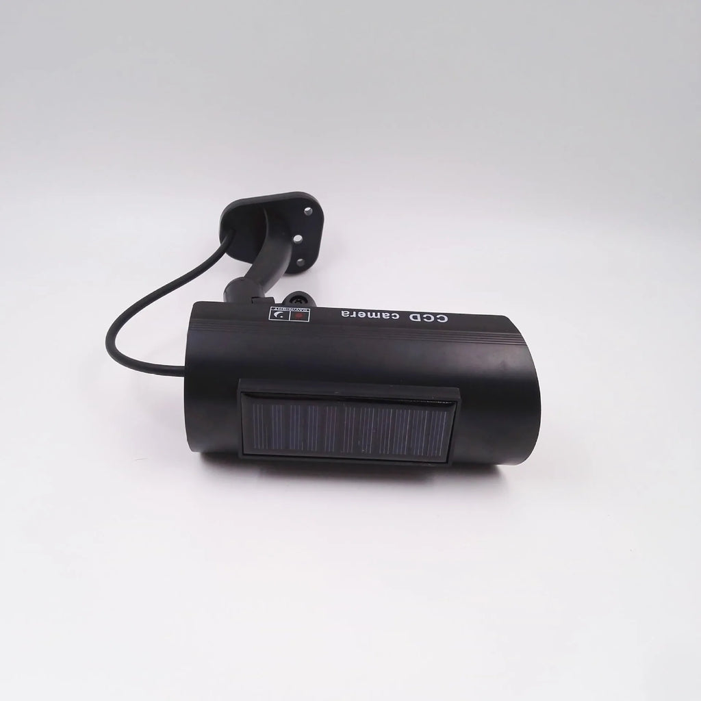 Black plastic fake security camera with gun-style design and solar simulation LED light