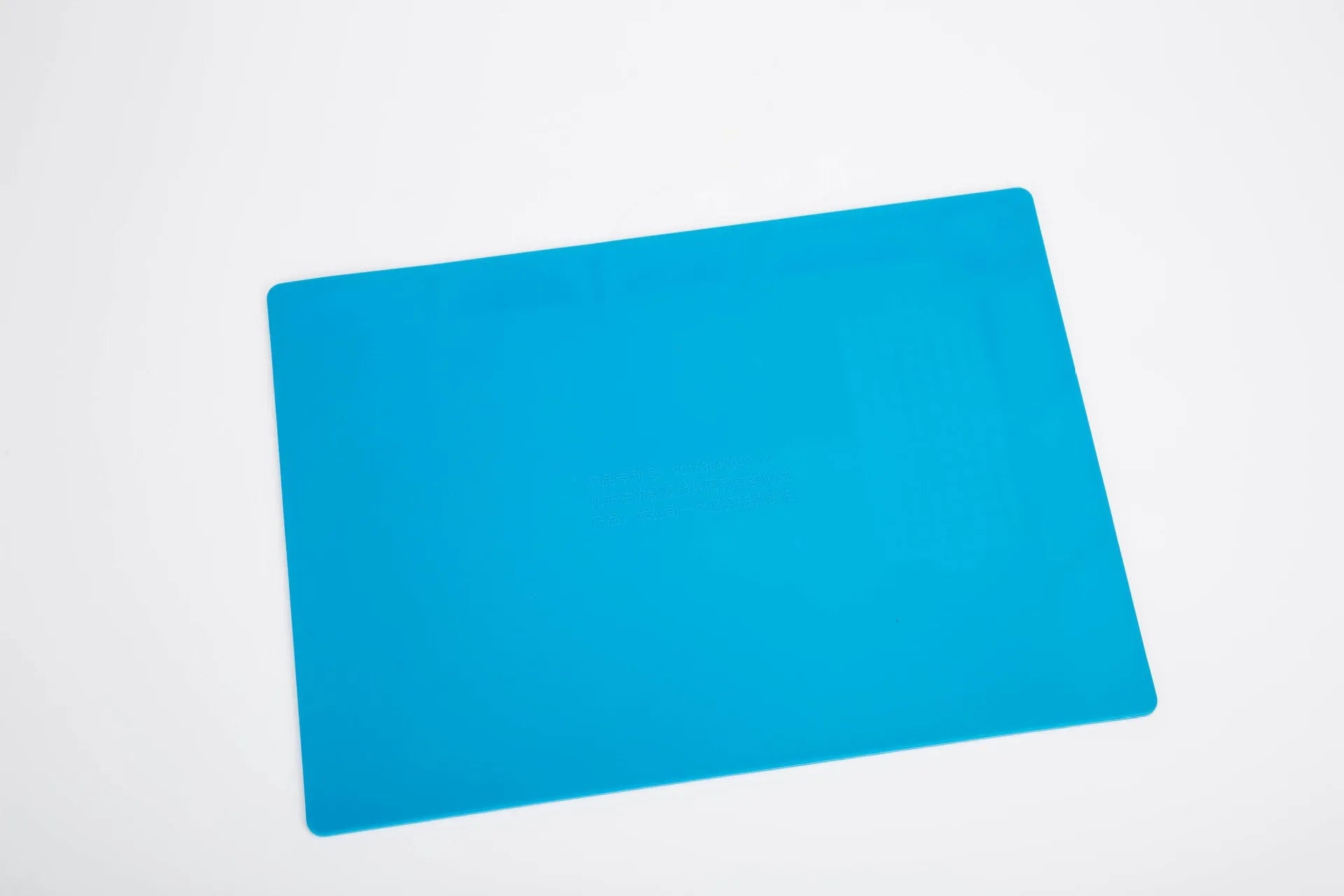 Blue silicone watch repair table mat with a non-slip surface for securing small components.