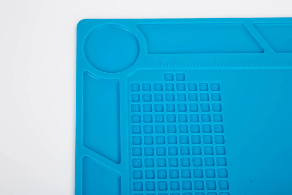Blue silicone watch repair table mat with a non-slip surface for securing small components.