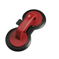Black and red round burger press mould with oil paper liners on a kitchen counter.