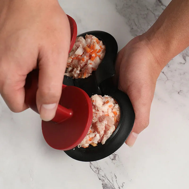 Black and red round burger press mould with oil paper liners on a kitchen counter.