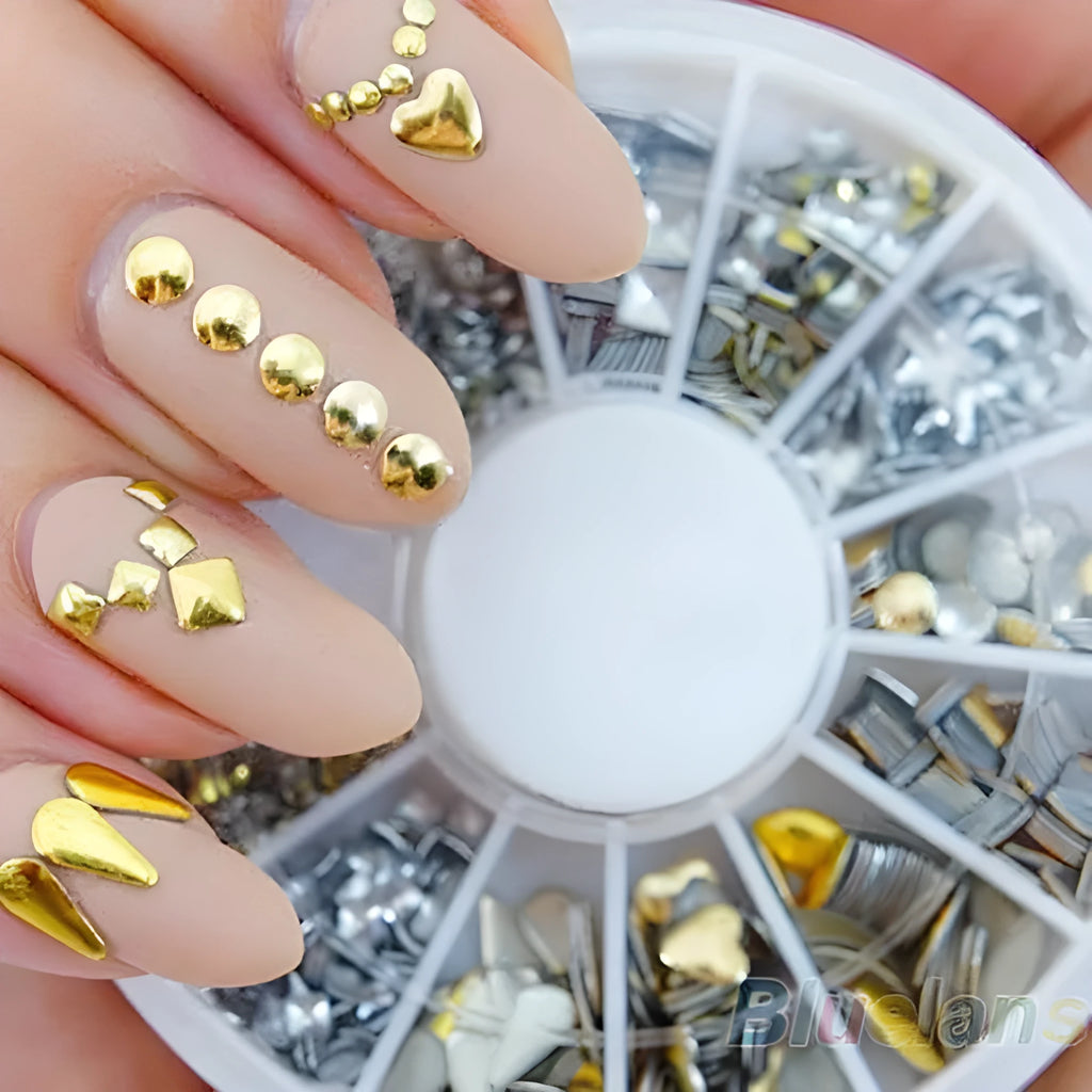 Gold acrylic nail art stickers on a finger showing decorative self-adhesive design