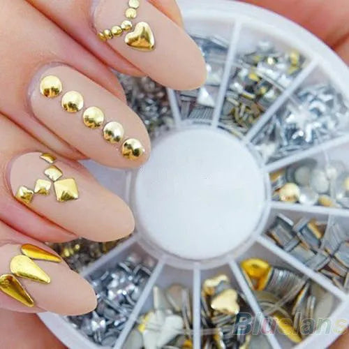 Gold acrylic nail art stickers on a finger showing decorative self-adhesive design