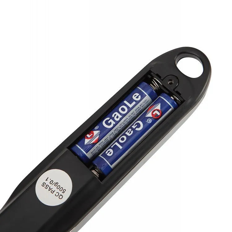 Smart digital kitchen measuring spoon with LCD display showing weight measurement.