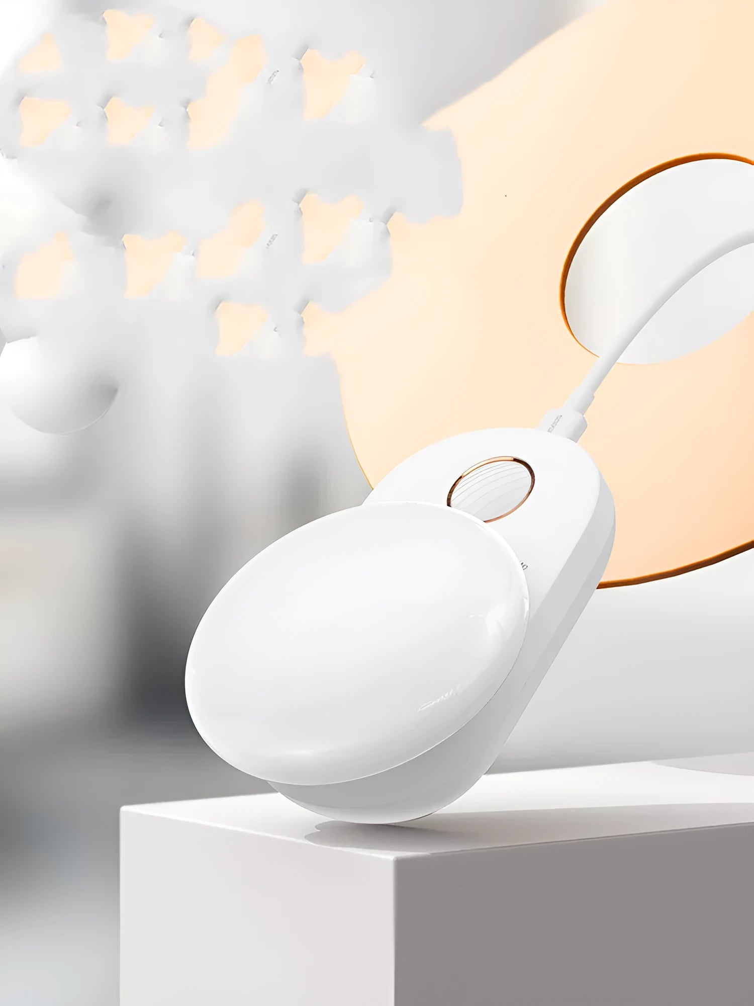 White USB rechargeable sensor night light with warm LED glow, shown on a bedroom nightstand.