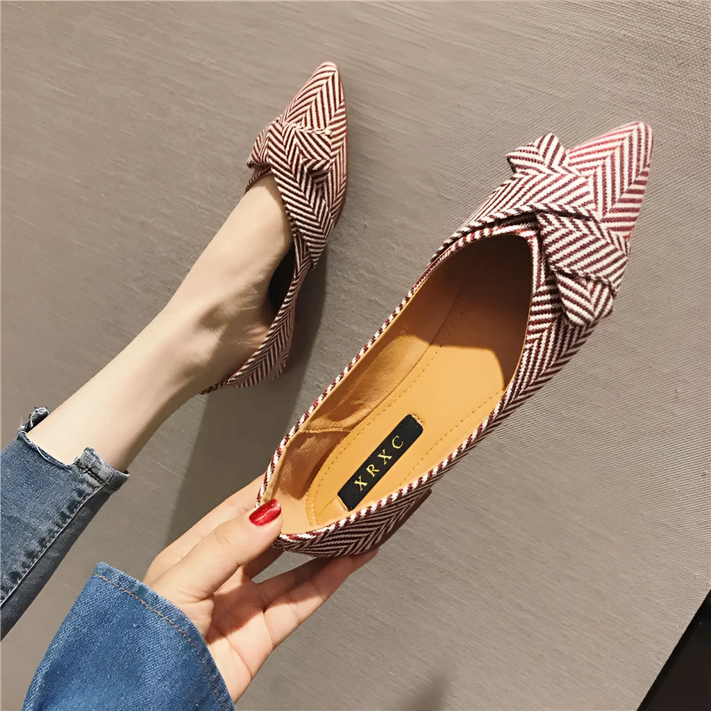 Women's pointed toe shallow mouth shoes in red and black with a low flat heel.