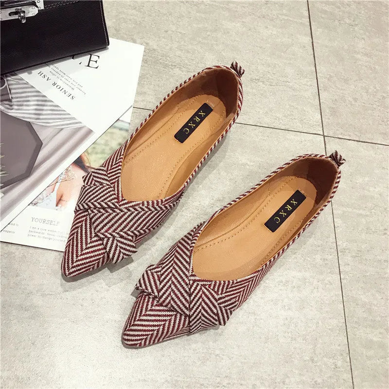 Women's pointed toe shallow mouth shoes in red and black with a low flat heel.