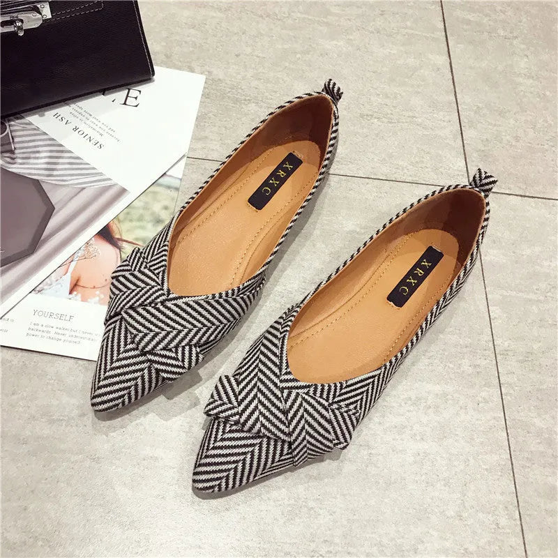 Women's pointed toe shallow mouth shoes in red and black with a low flat heel.