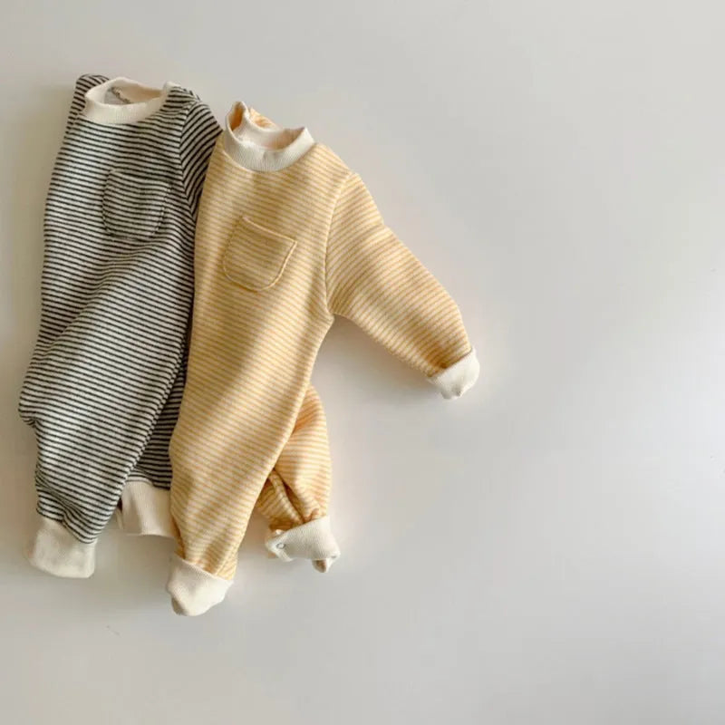 Yellow and black striped fleece-lined cotton baby jumpsuit with long sleeves on a hanger.