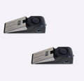 Black portable door stop alarm with wedge shape and stainless steel sensor cover.