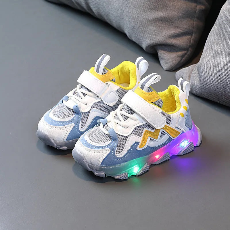 Children's black breathable mesh sneakers with a Velcro fastening strap and rubber sole.