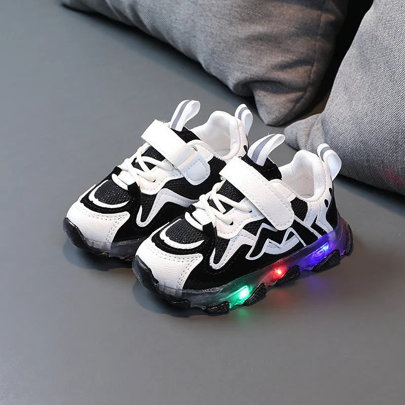 Children's black breathable mesh sneakers with a Velcro fastening strap and rubber sole.