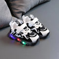 Children's black breathable mesh sneakers with a Velcro fastening strap and rubber sole.