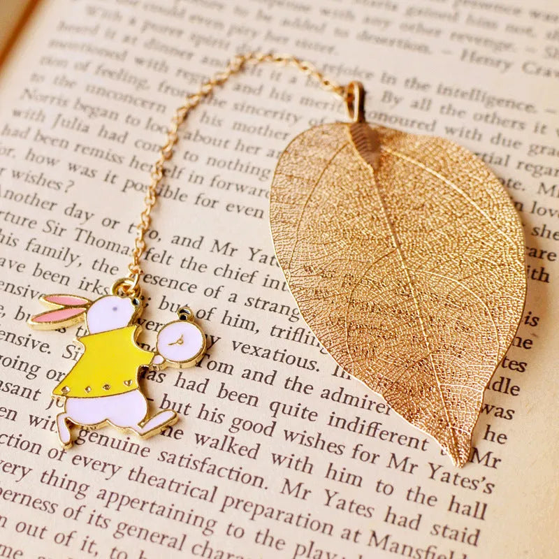 KC alloy leaf-shaped bookmark with a choice of Alice, rabbit, or clock charm attachment.