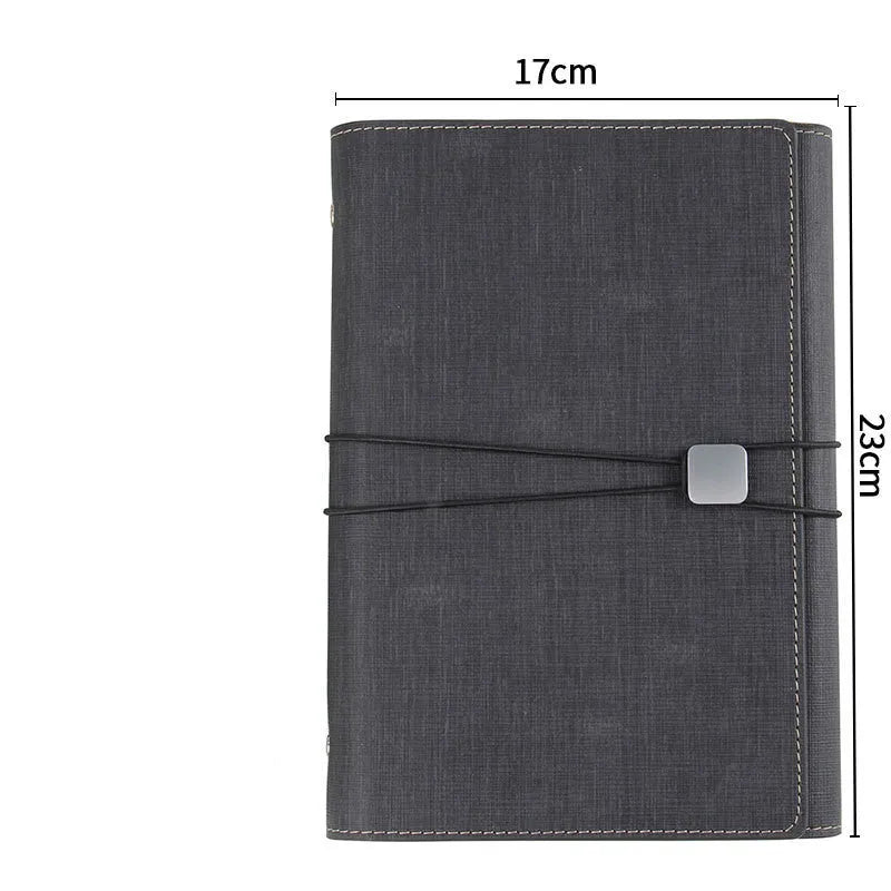 A5 loose-leaf tri-fold notebook with imitation leather cover, open showing beige paper pages