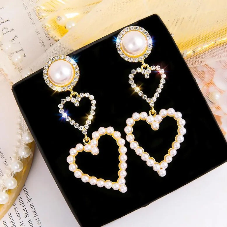 Pair of gold pearl rhinestone drop earrings on a plain background, measuring 7x2.5cm