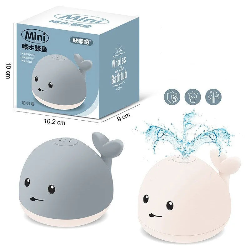 Colourful whale-shaped bath toy spraying water with LED lights illuminated