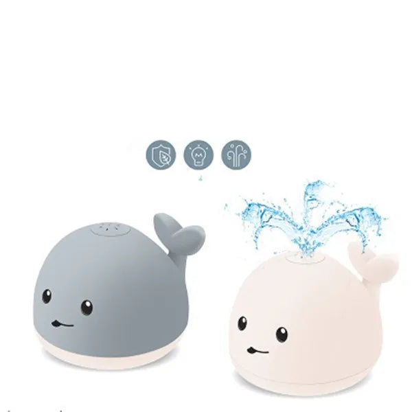 Colourful whale-shaped bath toy spraying water with LED lights illuminated