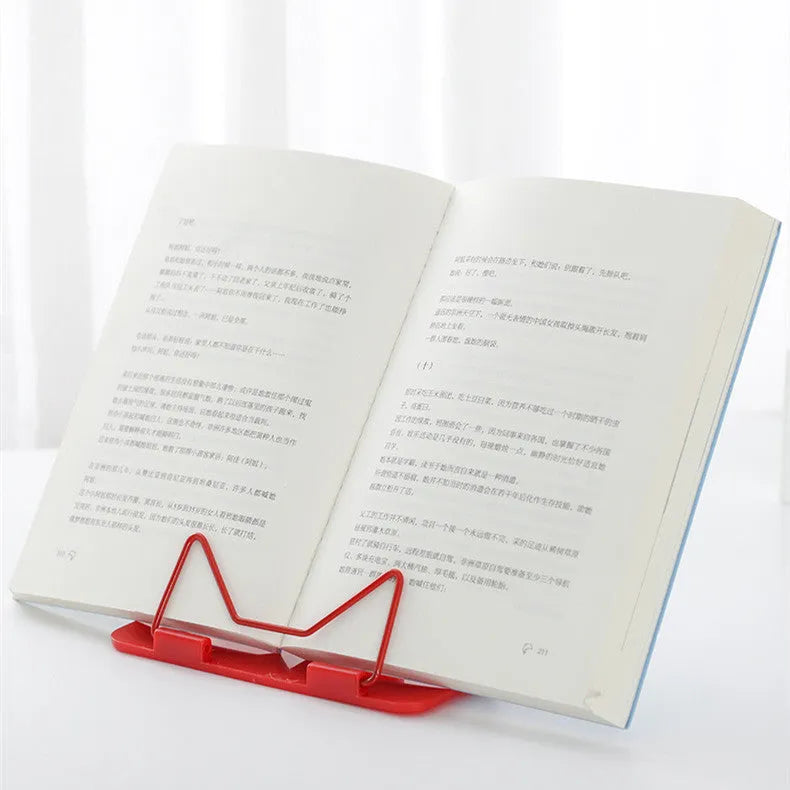 Blue metal and plastic reading frame holding book upright at angle on desk