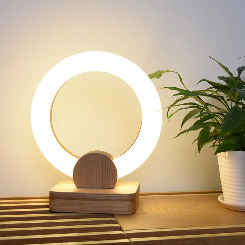 Modern circular acrylic LED chandelier in Nordic style, shown in a living room setting.
