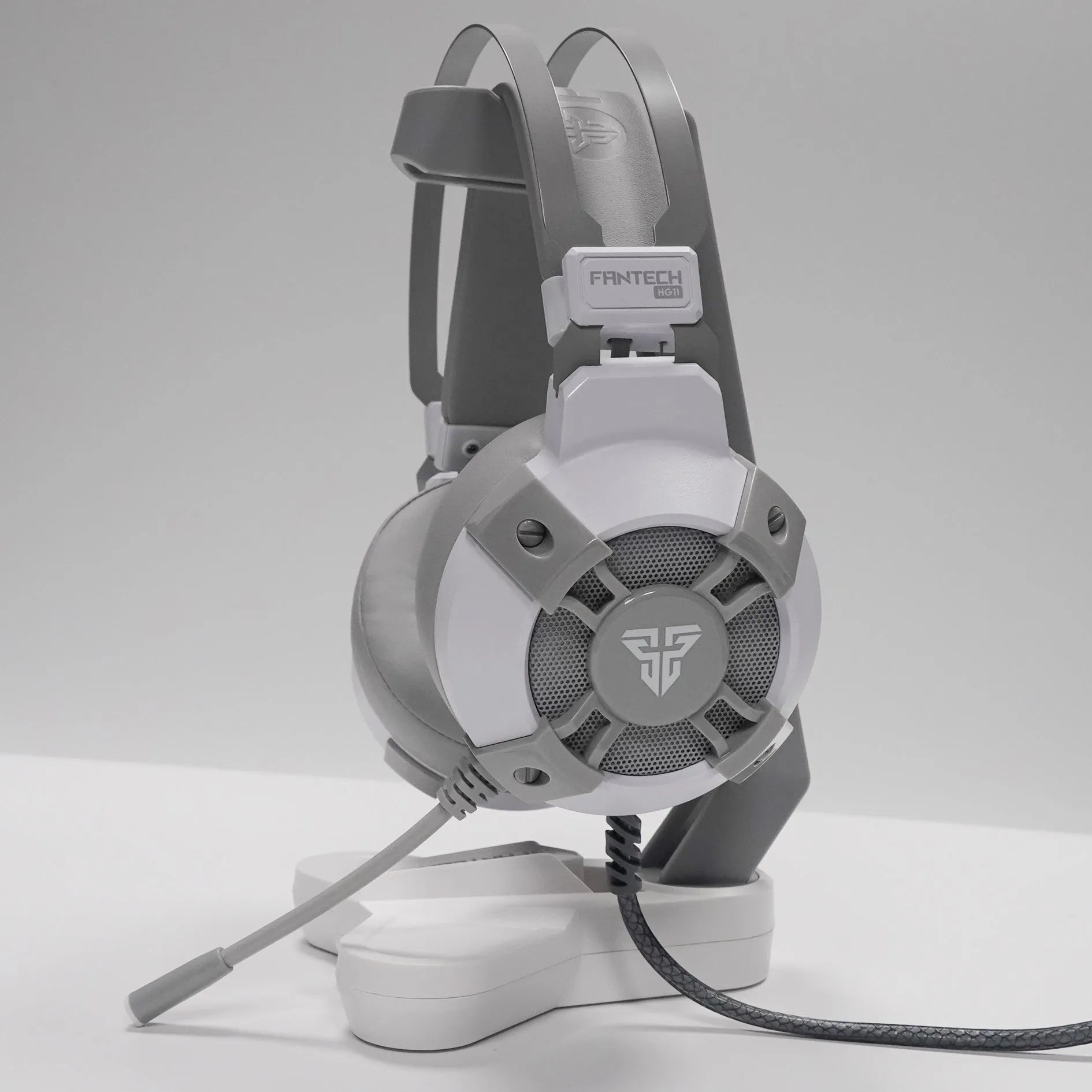 Black FANTECH HG11 USB gaming headset with large ear cups, RGB lighting, and a cable with inline remote control.