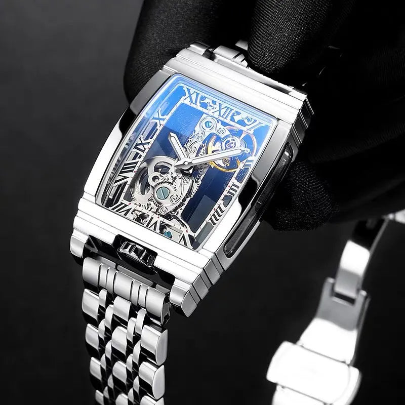 Daystar square stainless steel watch with mechanical movement on a leather strap, showing white dial and case.