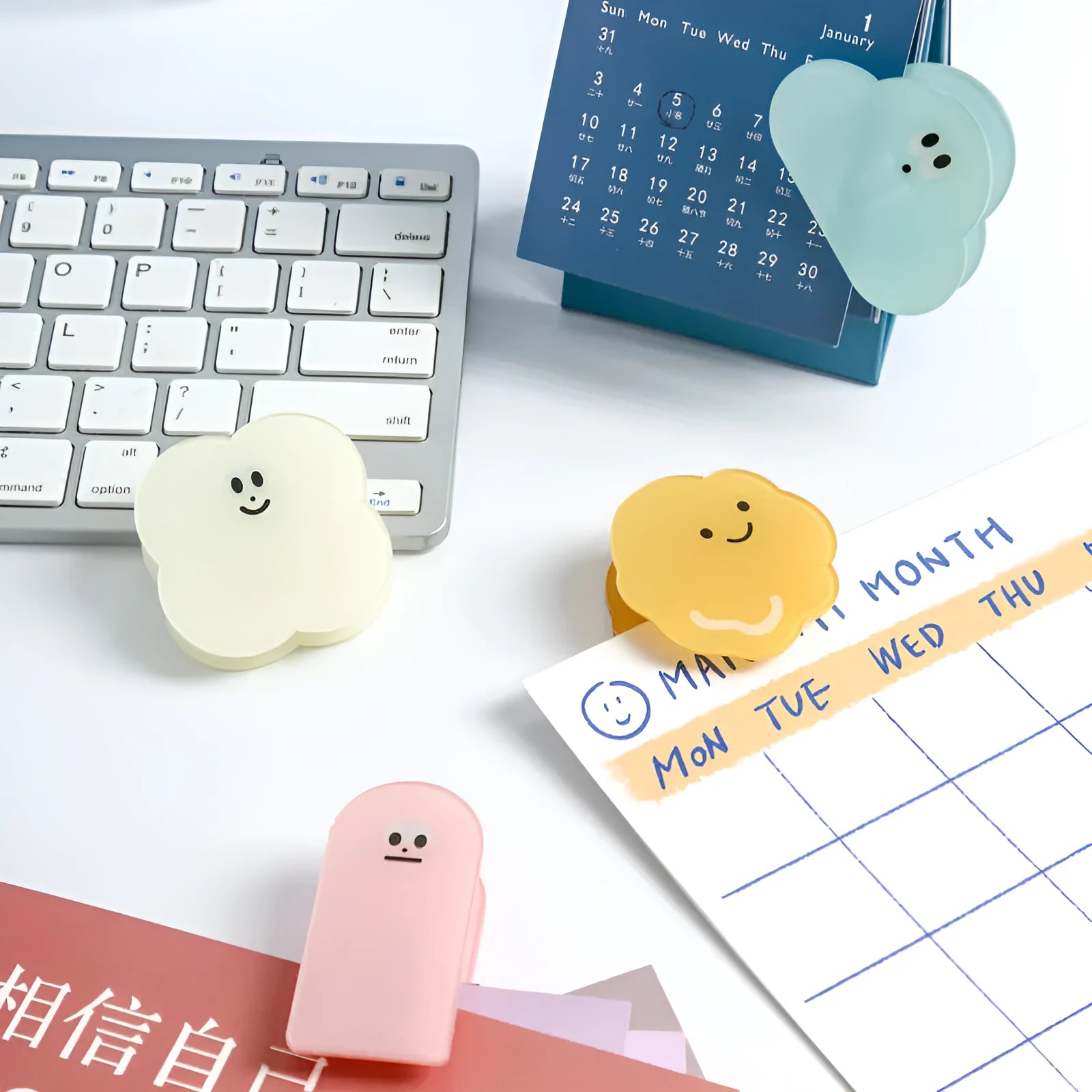 Square translucent acrylic cartoon collage clip in beige, blue, orange, and pink colours on a white background.