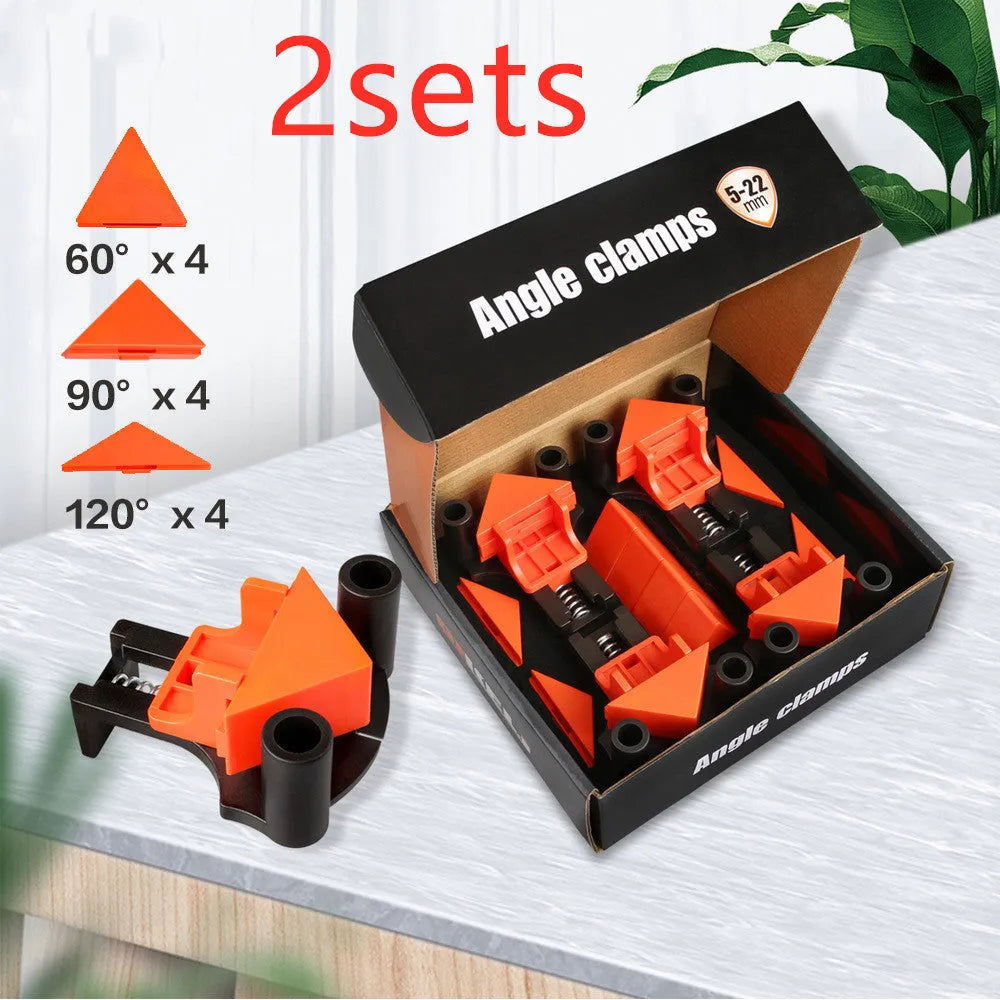 Set of four white plastic 90-degree right-angle clamps for picture frames on a workbench.