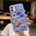 Purple silicone iPhone case with a cartoon astronaut design, shown fitted on a phone.