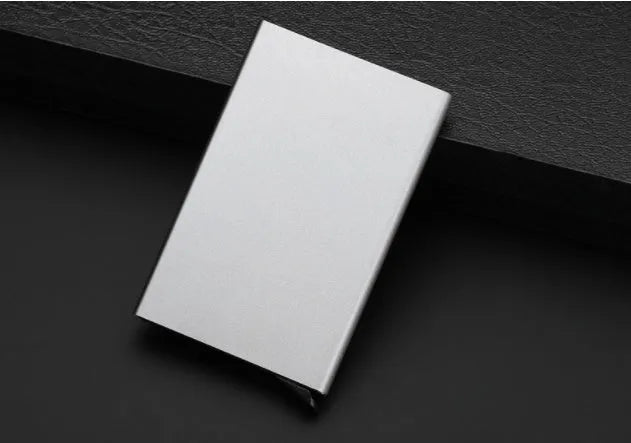 Aluminium geometric business card holder in metallic colours on desk