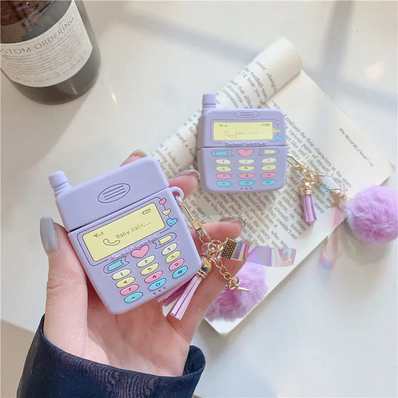 Purple silicone protective case for Apple AirPods with a small white fur ball pendant attached.