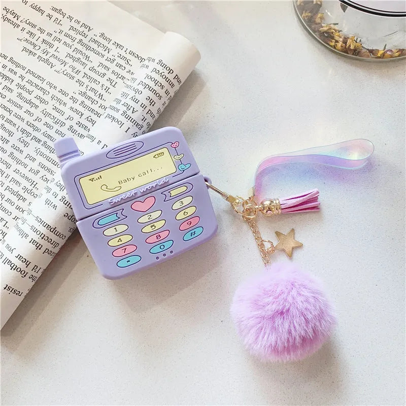 Purple silicone protective case for Apple AirPods with a small white fur ball pendant attached.