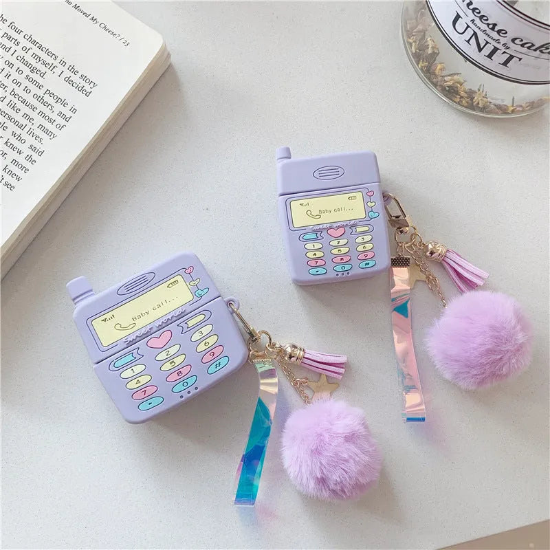 Purple silicone protective case for Apple AirPods with a small white fur ball pendant attached.