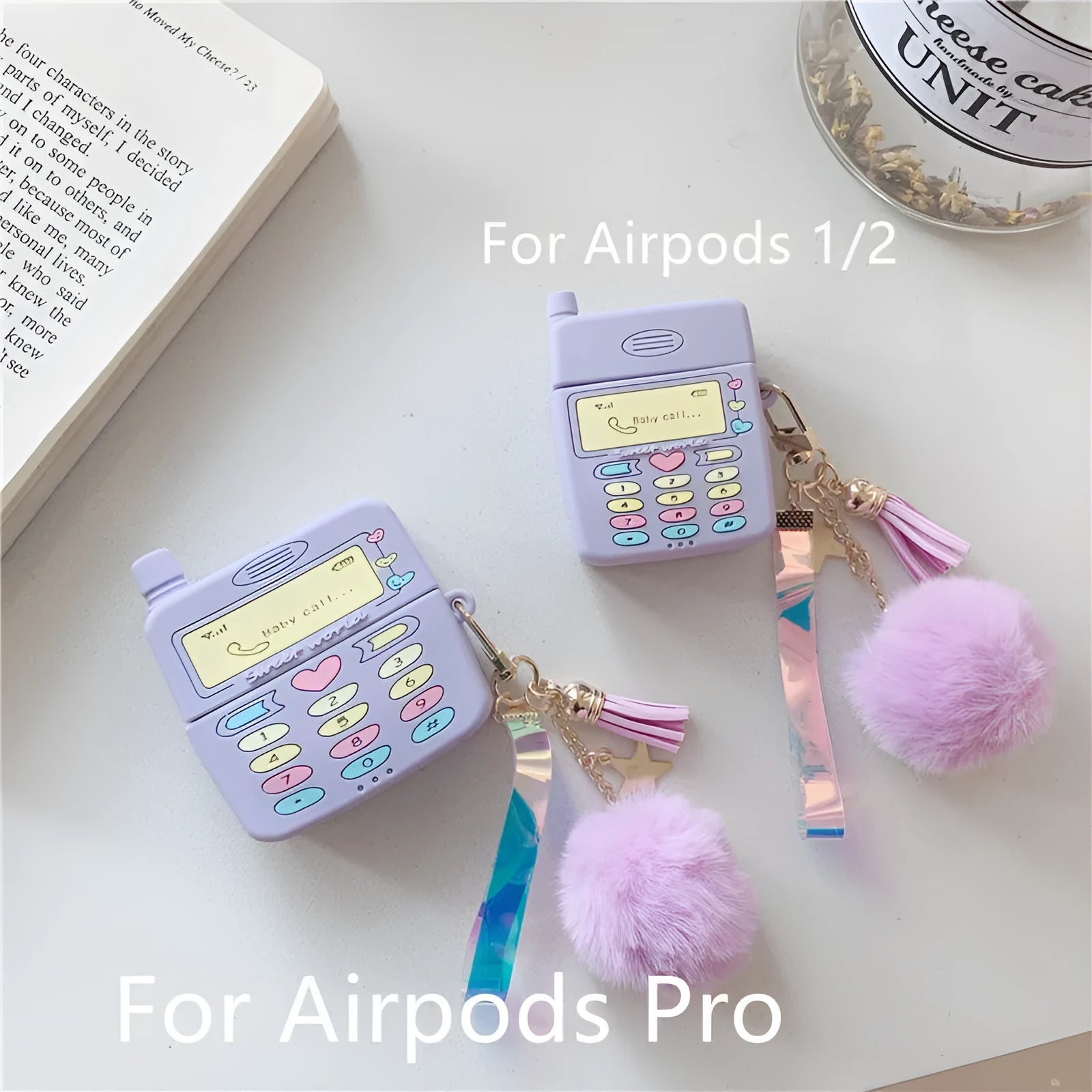 Purple silicone protective case for Apple AirPods with a small white fur ball pendant attached.