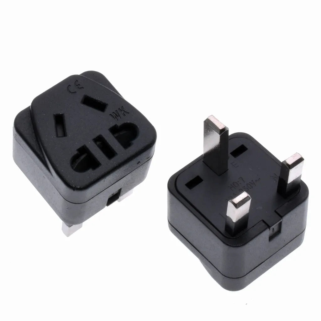 Square white UK to international power adapter with five sockets and a grounded three-pin plug.