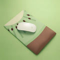 Thick grey wrist support mouse pad with a cute printed design, showing its 20mm elevated rest.