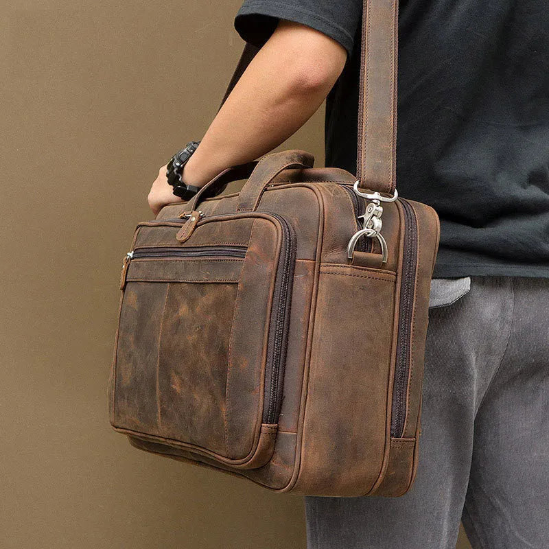 Men's dark brown Crazy Horse leather laptop bag, 43x15x30.5cm, with hard handle and zipper pockets.