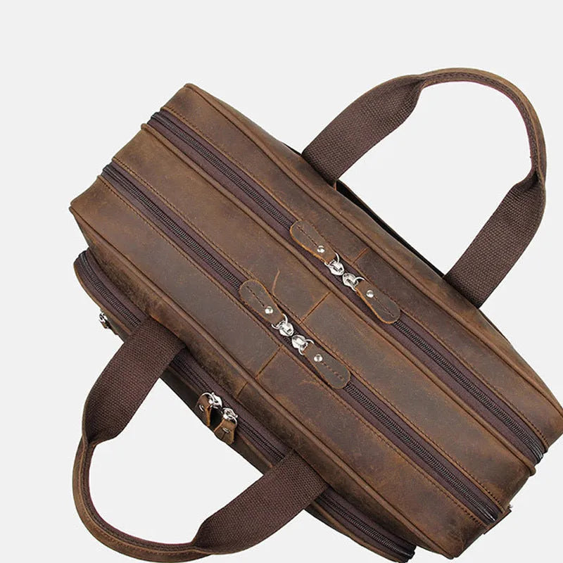 Men's dark brown Crazy Horse leather laptop bag, 43x15x30.5cm, with hard handle and zipper pockets.