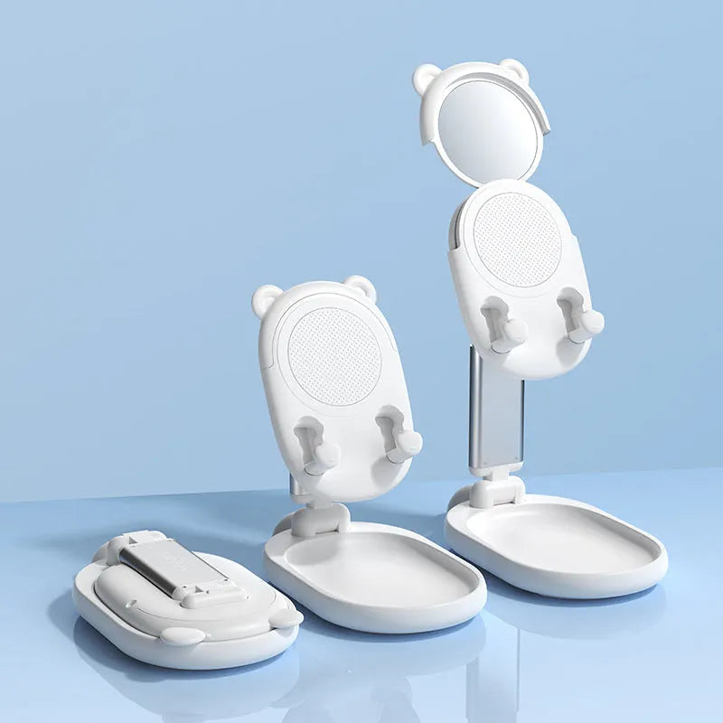 Blue adjustable aluminium and PC phone tablet stand with mirror on a wooden desk.