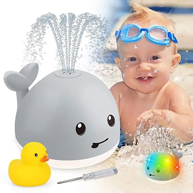 Colourful whale-shaped bath toy spraying water with LED lights illuminated