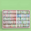 100 rolls of antique character printed hand account tape in a box showing multiple widths and colours