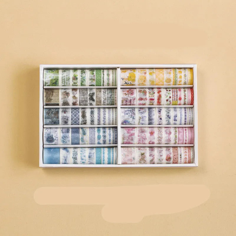 100 rolls of antique character printed hand account tape in a box showing multiple widths and colours